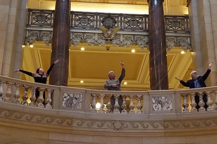 Three actors standing in the rotunda of the Minnesota State Capitol Building 