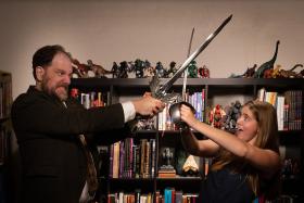 A man and a woman in a sword fight