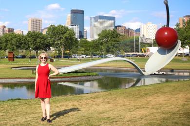 Jill Schafer stands in front of the iconic Cherry and Spoon Bridge at the Walker Sculpture Garden 