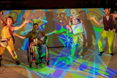 (From left to right) Jennifer Ilse, Gabriel Rodreick, Paul Herwig, and Jesse Schmitz-Boyd pose in front of psychedelic graphics.