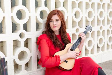 Portrait of Mandy Harvey holding an instrument. 