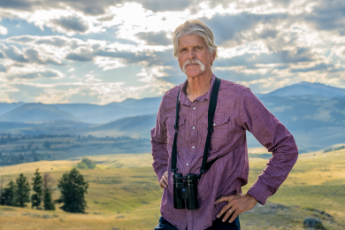 Photograph of Doug Smith in front of the Yellowstone Park landscape. 