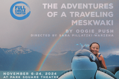 Overcast sky with rainbow, mountain range in the background with body of water at the bottom of the mountains. In front of the landscape image is playwright and lead performer Oogie Push on an inflatable orca whale.