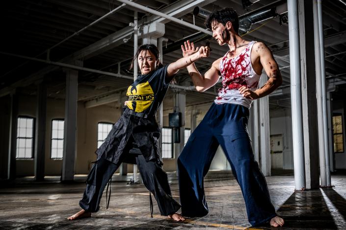 A zombie (Kobe Markworth) blocks a punch by shaman warrior Arun (played by Hannah Nguyen)