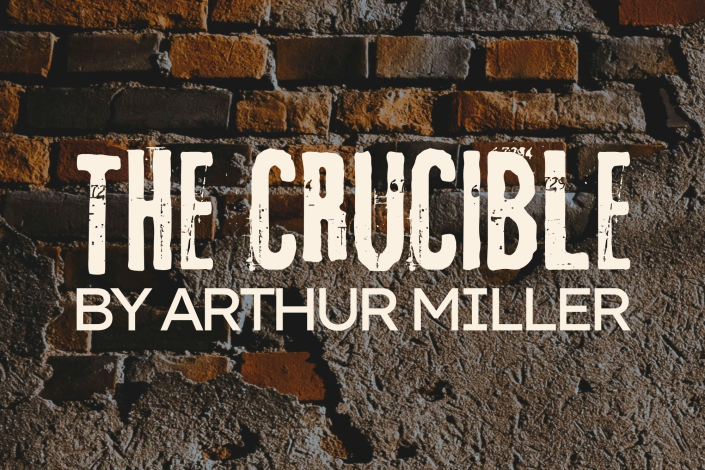 Crumbling brick wall with the words The Crucible by Arthur Miller