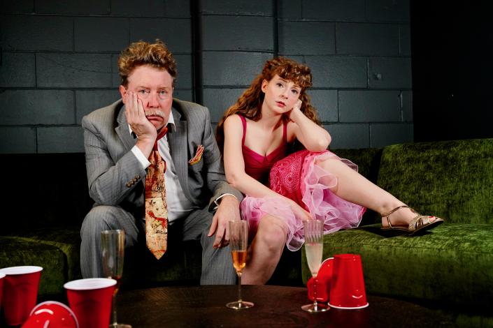 Two redheaded actors all dressed up and bored as hell at a party