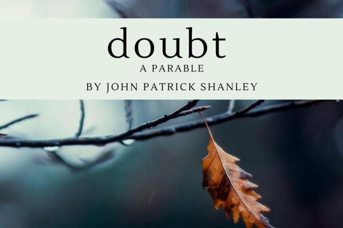 image of a single brown leaf hanging from a tree branch. The text "Doubt a Parable by John Patrick Shanley" is on a light greet bar across the top.