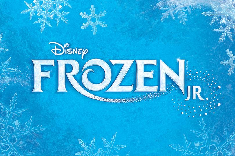 The image shows the words Disney's Frozen JR. in white text with sharp angles. The text is on a blue background and surrounded by crystal snowflakes.