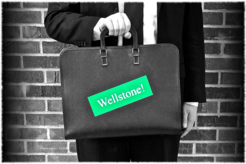 Logo for "Wellstone: A Minnesotan Musical" featuring a man holding a briefcase, adorned with a vintage "Wellstone!" bumper sticker. 