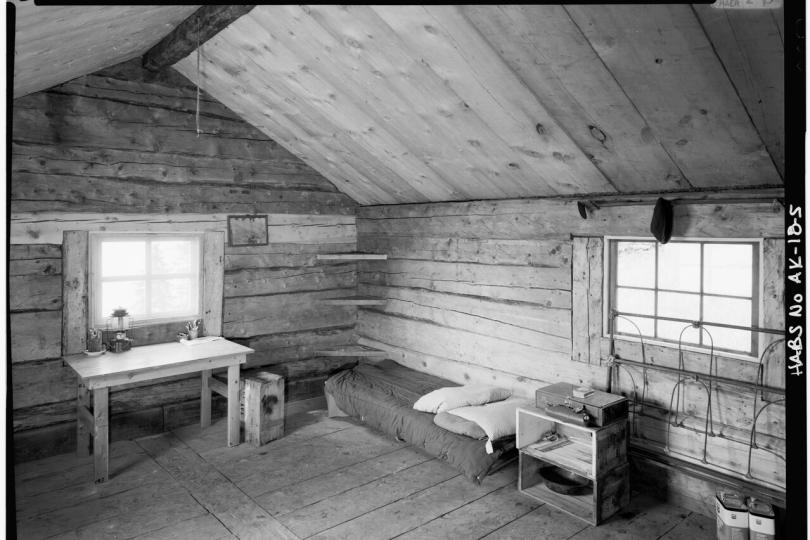 A black and white photo of a cabin.