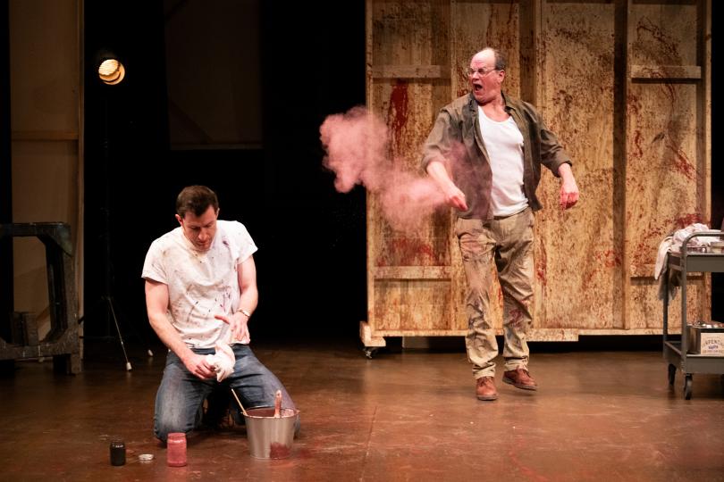 two painters work on a stage