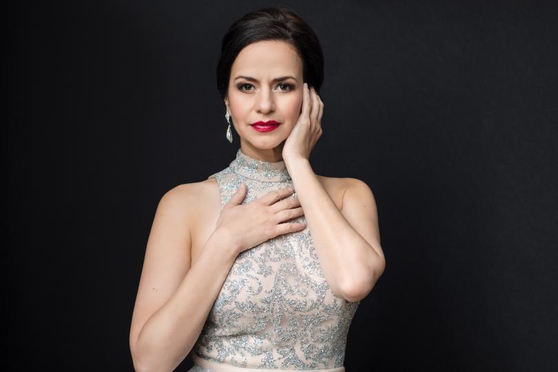 Portrait of Mandy Gonzalez in a silver dress.